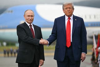 US president Donald Trump greets Russian president Vladimir Putin on the tarmac after they arrived at Joint Base Elmendorf-Richardson in Anchorage in Alaska