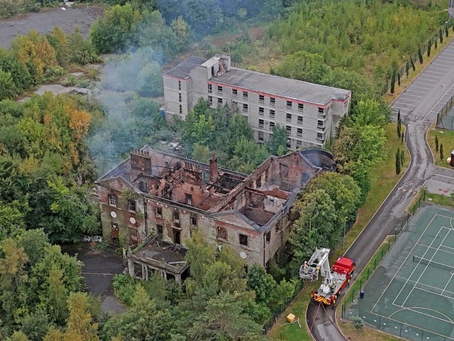<p>Fire crews continue to work at the scene of Woolton Hall in Liverpool, following a fire at the Grade I-listed manor house </p>