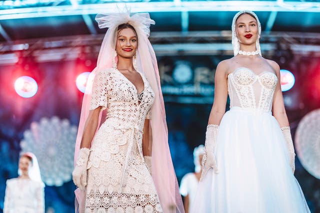 <p>Models showcase handmade wedding dresses crafted from traditional lace at a fashion show in the village of Koniakow, in Poland's Beskid Mountains, Saturday, Aug. 16, 2025. (AP Photo/Daniel Franek)</p>