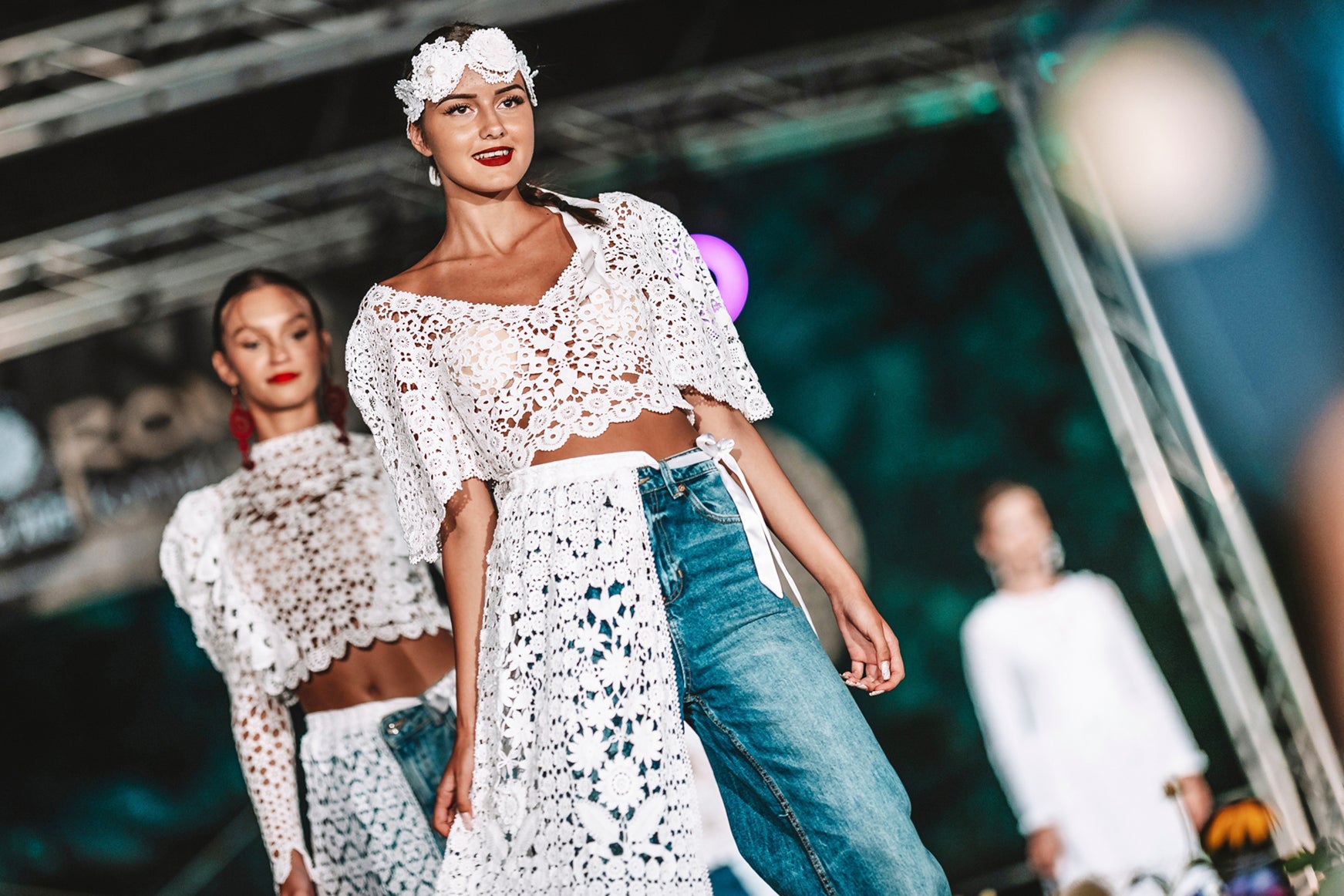 Models present hand-made lace outfits during a fashion show in the village of Koniakow, in Poland’s Beskid Mountains, Saturday, Aug. 16, 2025. (AP Photo/Daniel Franek)