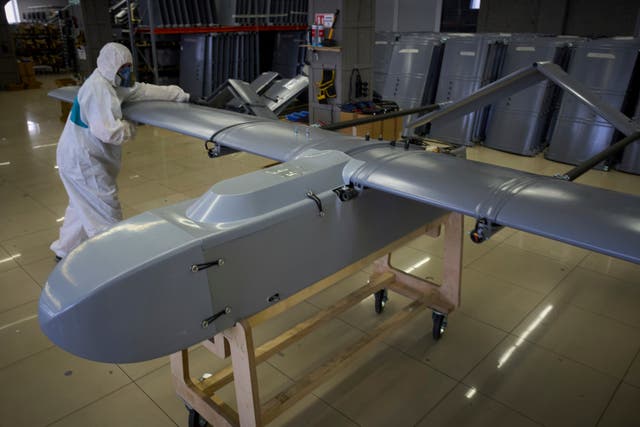 <p>A worker inspects a combat drone at Fire Point's secret factory in Ukraine</p>