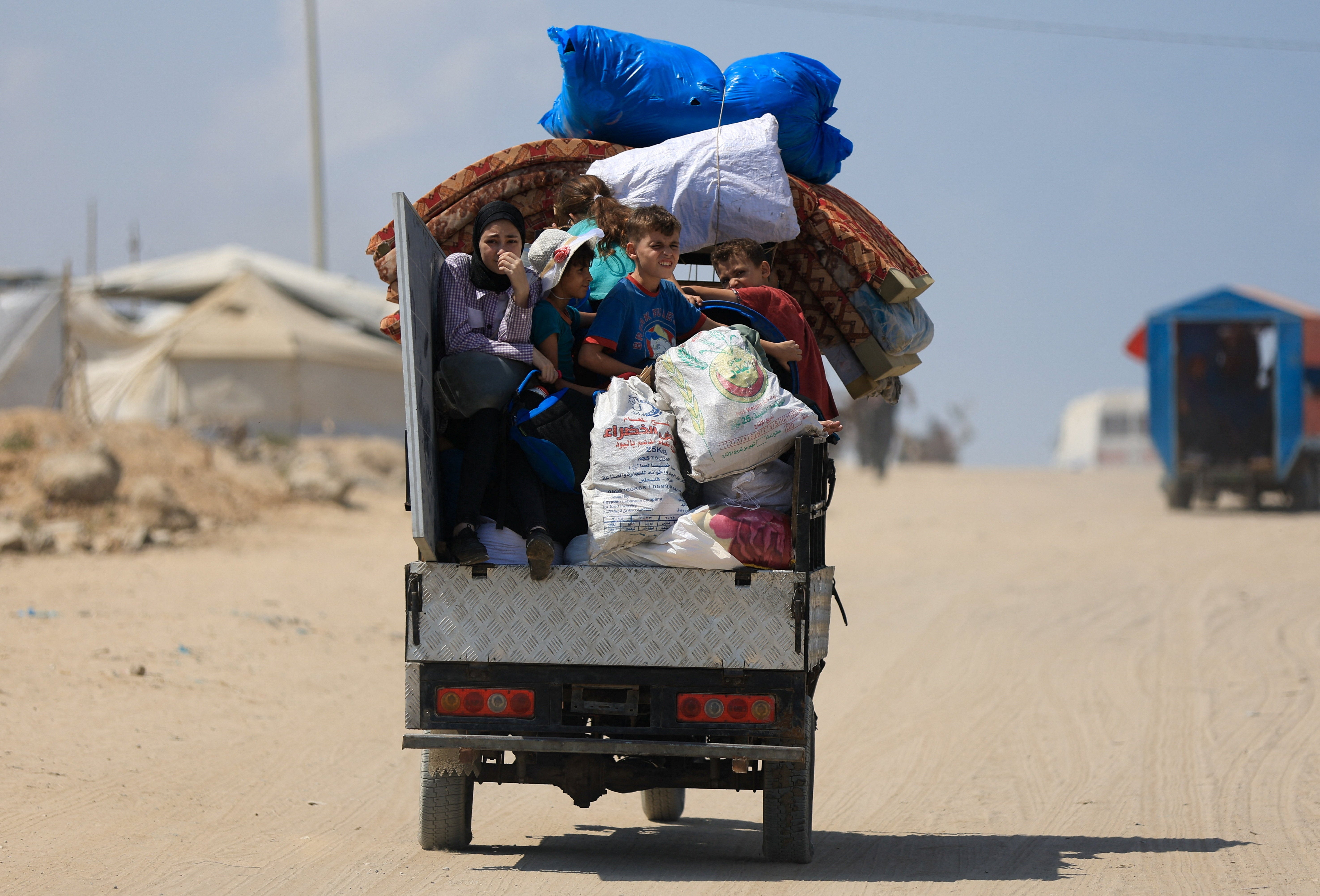 Displaced Palestinians fleeing northern Gaza ride with their belongings as they head south, amid an Israeli military operation, in Gaza City