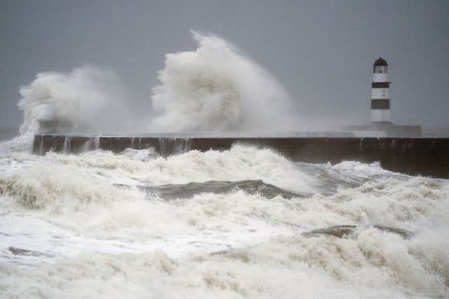 Waves crash against the lighthouse in Seaham Harbour, County Durham (Owen Humphreys/PA)