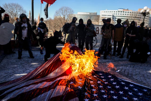 <p>Protesters burn an American flag at a demonstration in Denver. Trump is set to sign an order demanding the Department of Justice prosecute people for burning the flag. </p>
