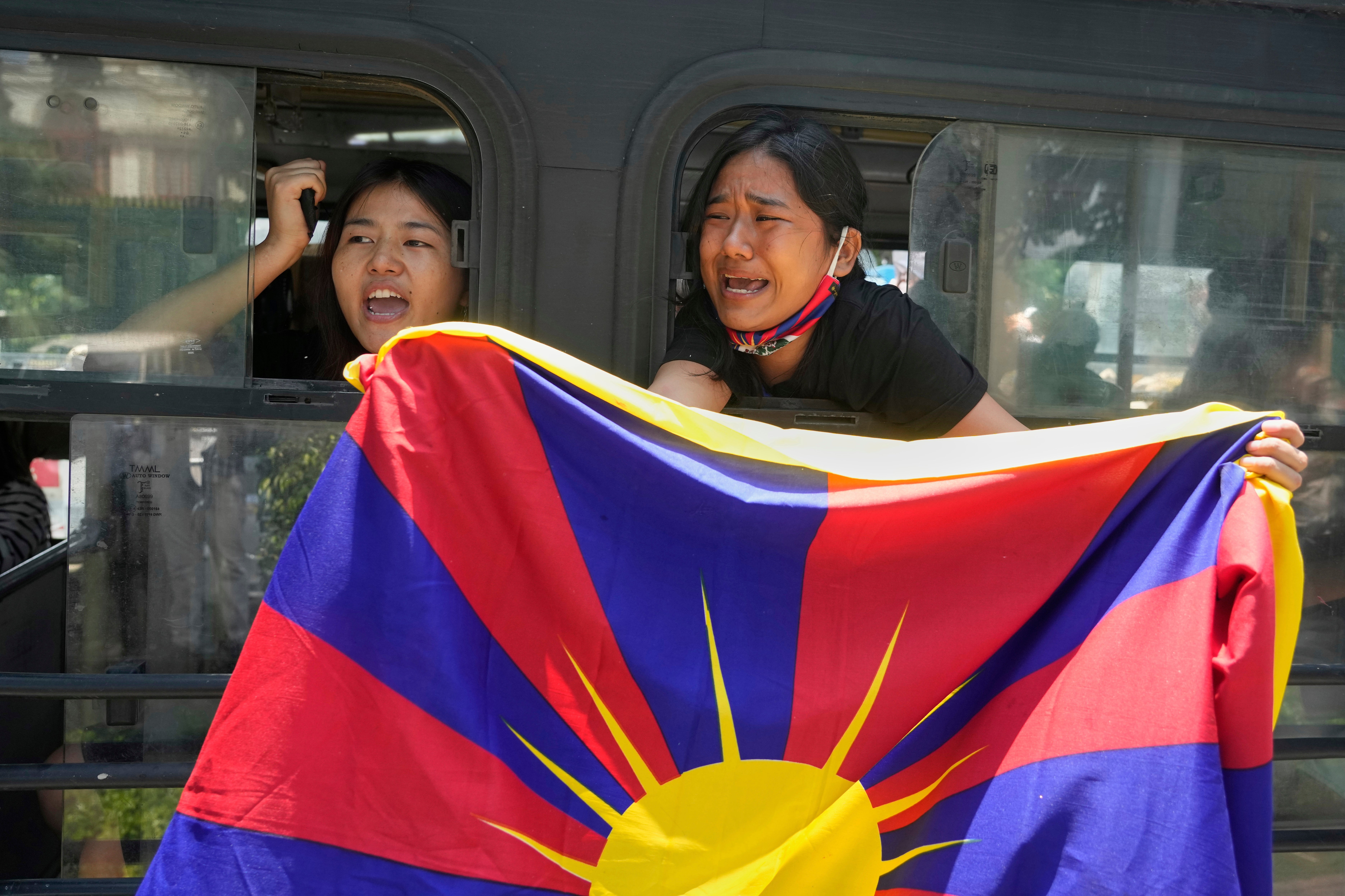 Exiled Tibetans shout slogans from a bus after being detained and taken to a police station during a protest against the visit of Chinese Foreign Minister Wang Yi to India, in New Delhi, India, on Tuesday, 19 August 2025