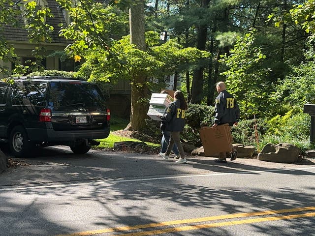 <p>FBI agents are seen outside the home of former national security adviser John Bolton.</p>
