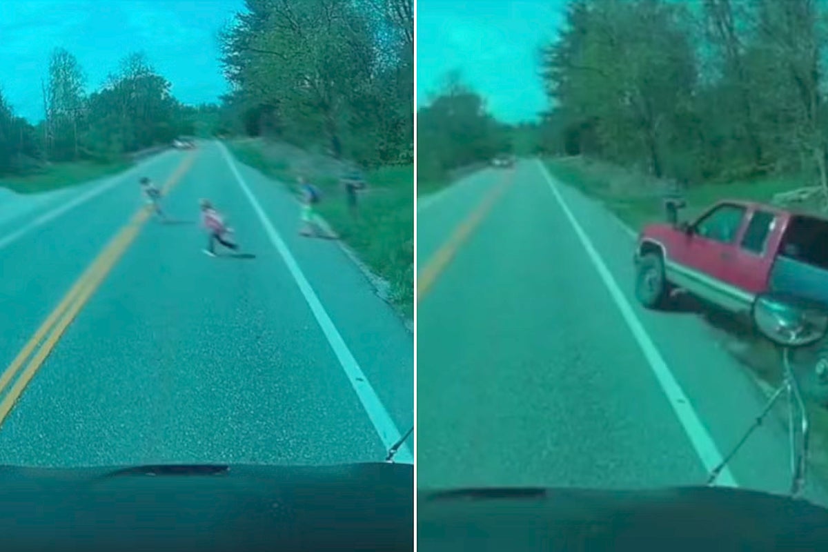 Moment overtaking pick-up truck narrowly misses children getting off school bus