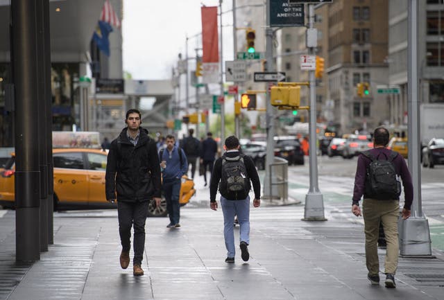 <p>Workers walk across New York City streets. More American employees are ‘quiet quitting’ their jobs. Now, researchers say they know why</p>