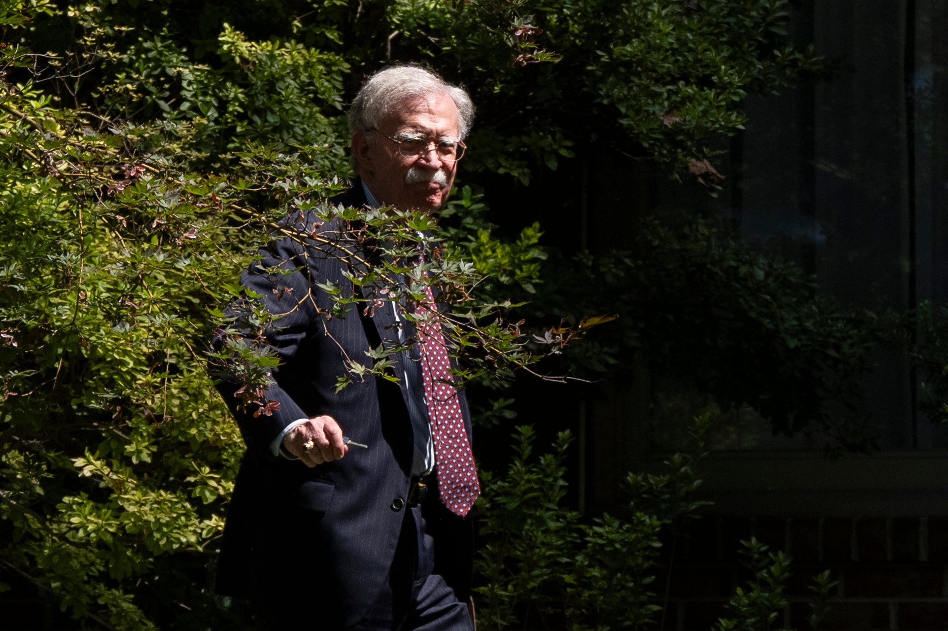Former national security adviser John Bolton arrives at his house Friday, August 22, 2025, in Bethesda, Maryland