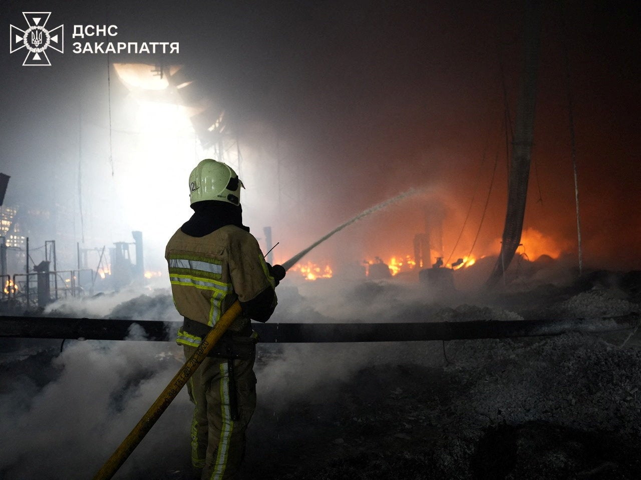 A firefighter works at the site where a Flextronics factory was hit by a Russian missile strike, amid Russia's attack on Ukraine, in Mukachevo, Zakarpattia region