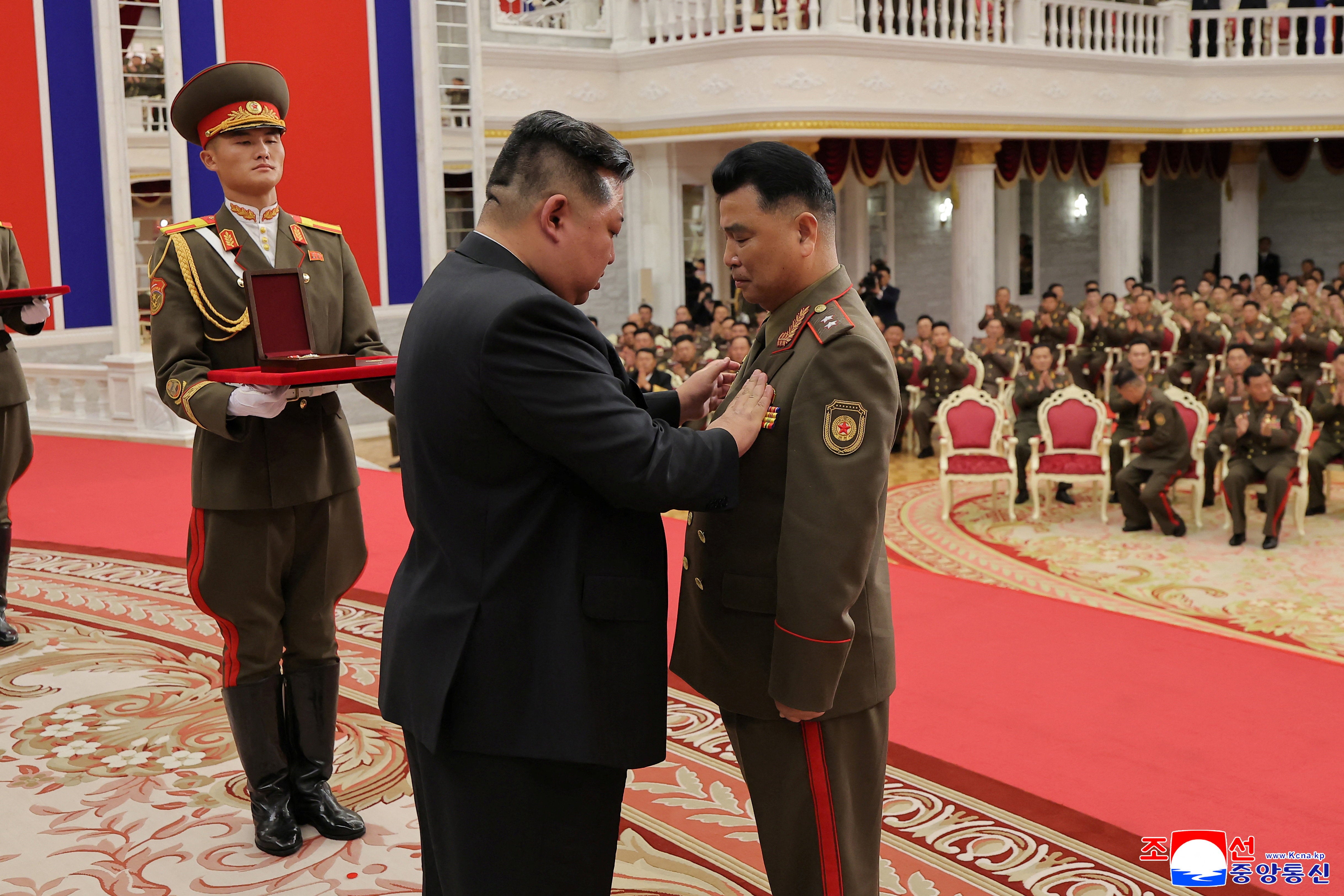 North Korean leader Kim Jong attends a national commendation ceremony for the commanders and fighters of the Korean People's Army's overseas operations unit, at the headquarters of the Central Committee of the Korean Workers' Party, in Pyongyang
