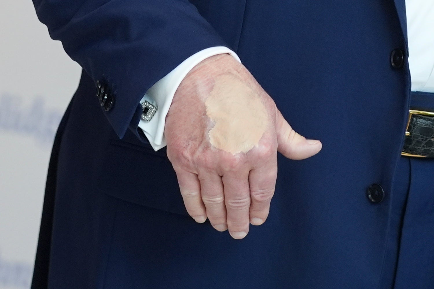 President Donald Trump speaks at The People's House museum on Friday in Washington DC, where heavy makeup was visible on his hand