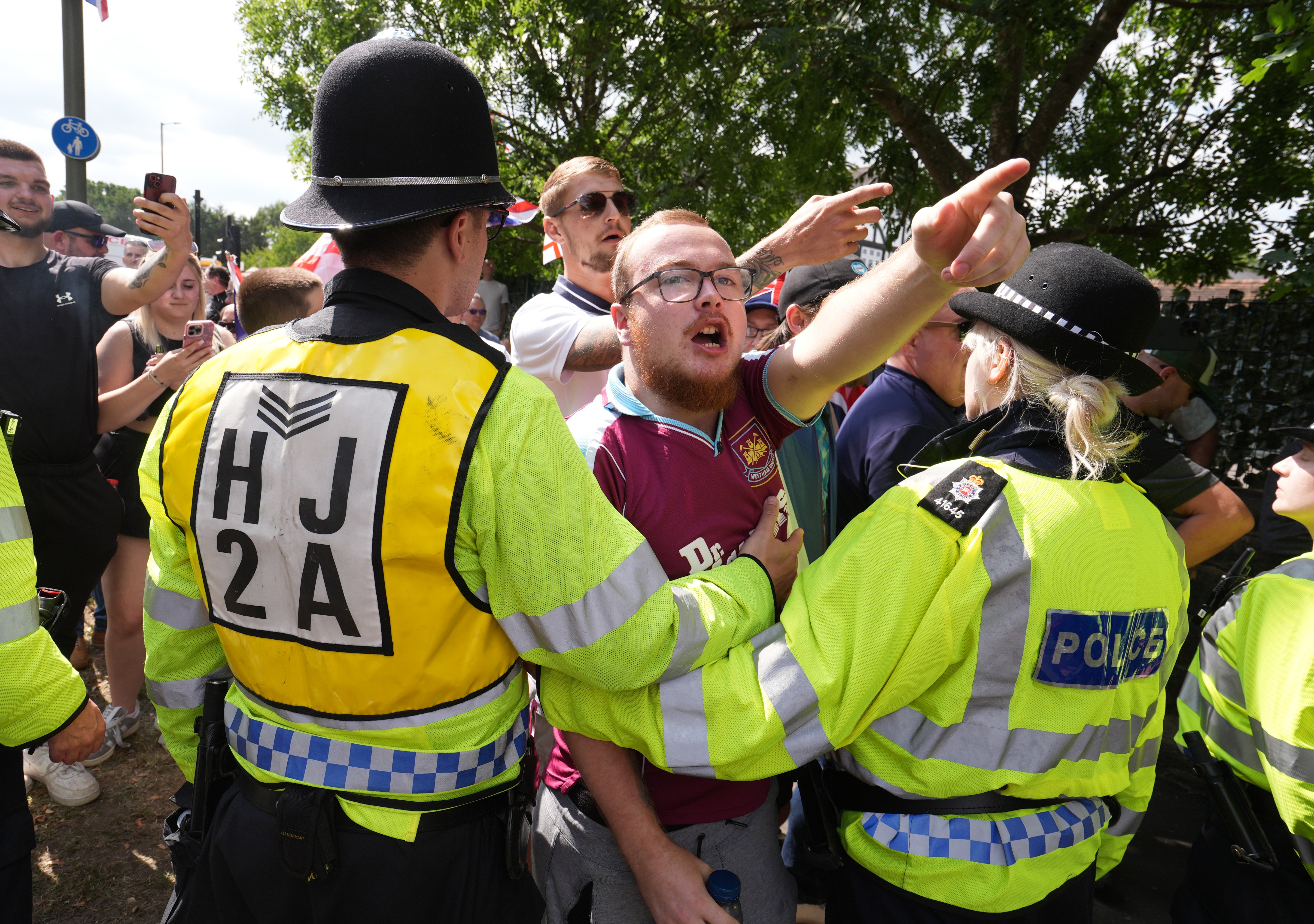 Police dealing with a protest and counter-protest in Horley (Gareth Fuller/PA)