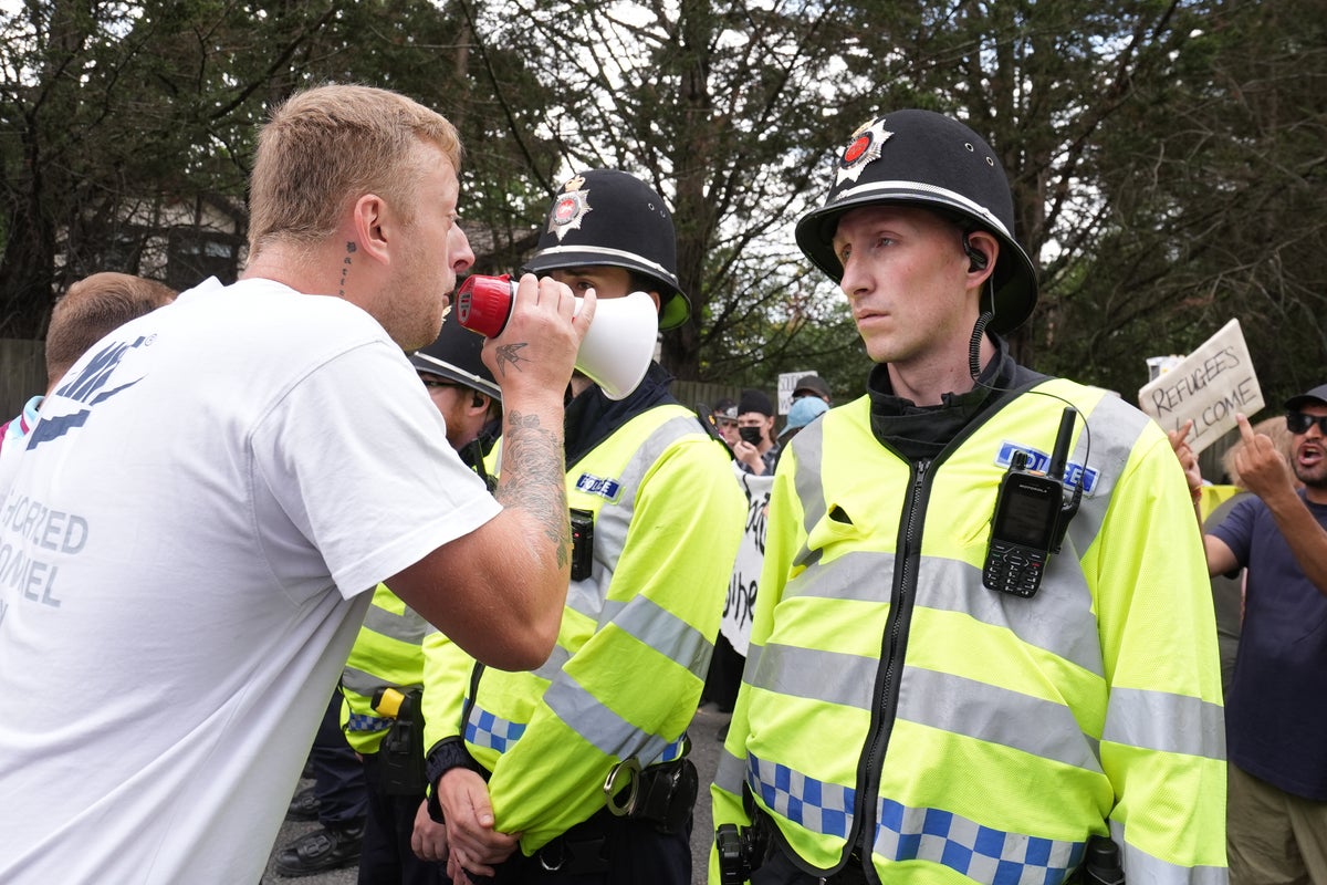Anti-migrant protesters hurl abuse as rival groups clash at Horley asylum hotel demonstration
