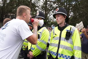 Anti-migrant protesters hurl abuse as rival groups clash in Horley
