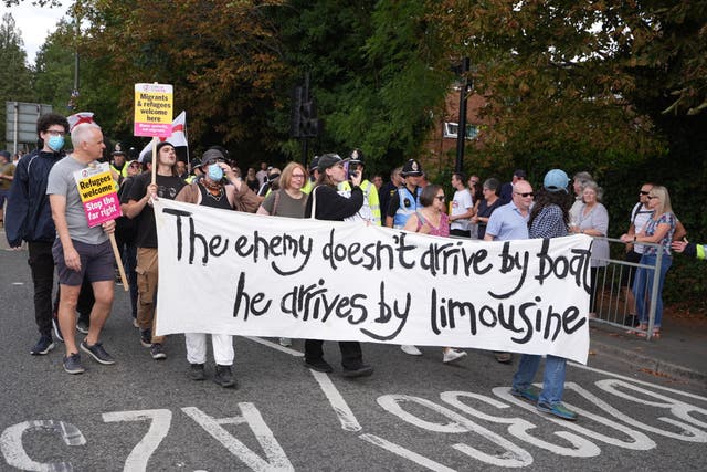 <p>People take part in a Stand Up to Racism rally outside the Sheraton Four Points Hotel in Horley</p>