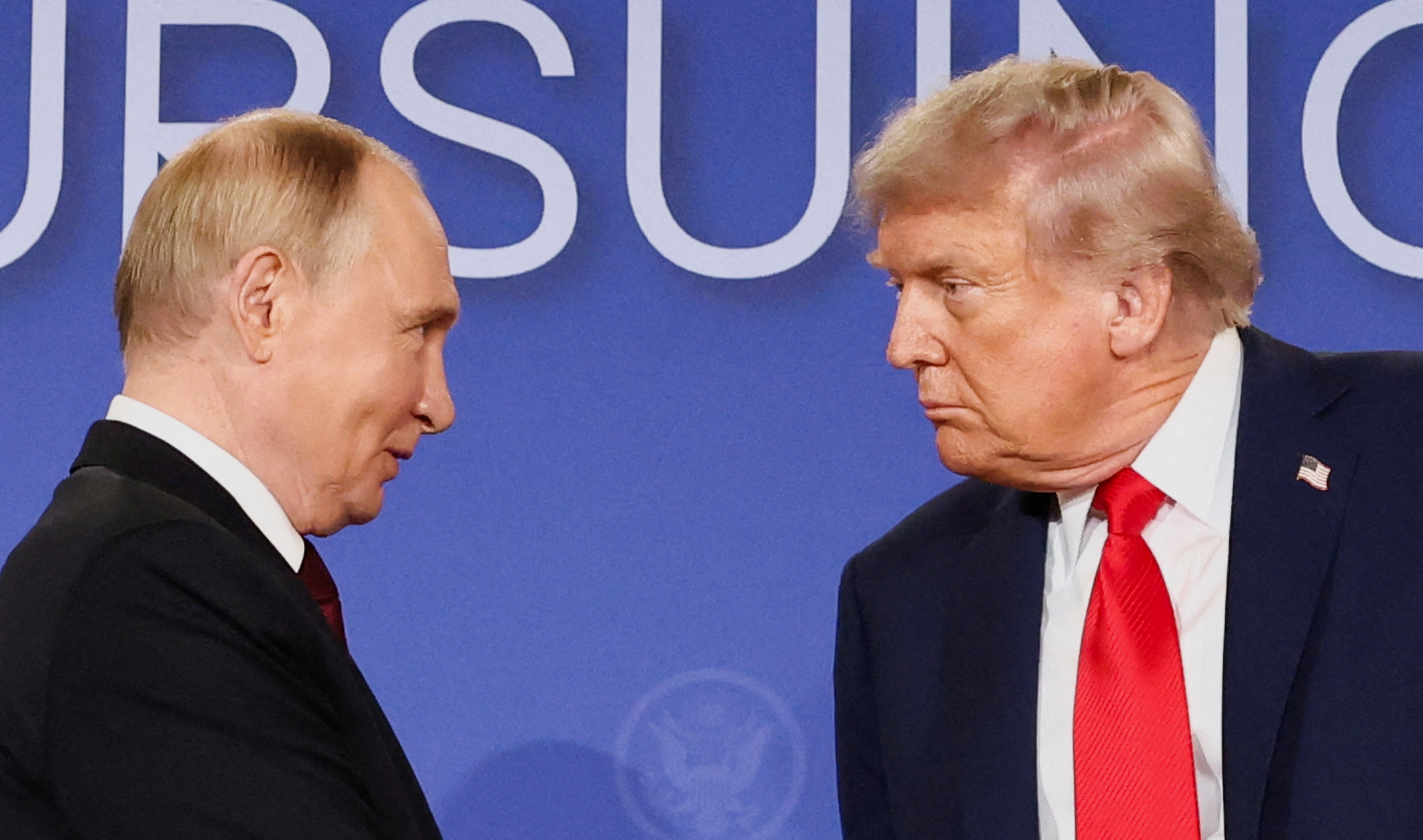 US president Donald Trump and Russian president Vladimir Putin look at each other during a press conference following their meeting to negotiate an end to the war in Ukraine