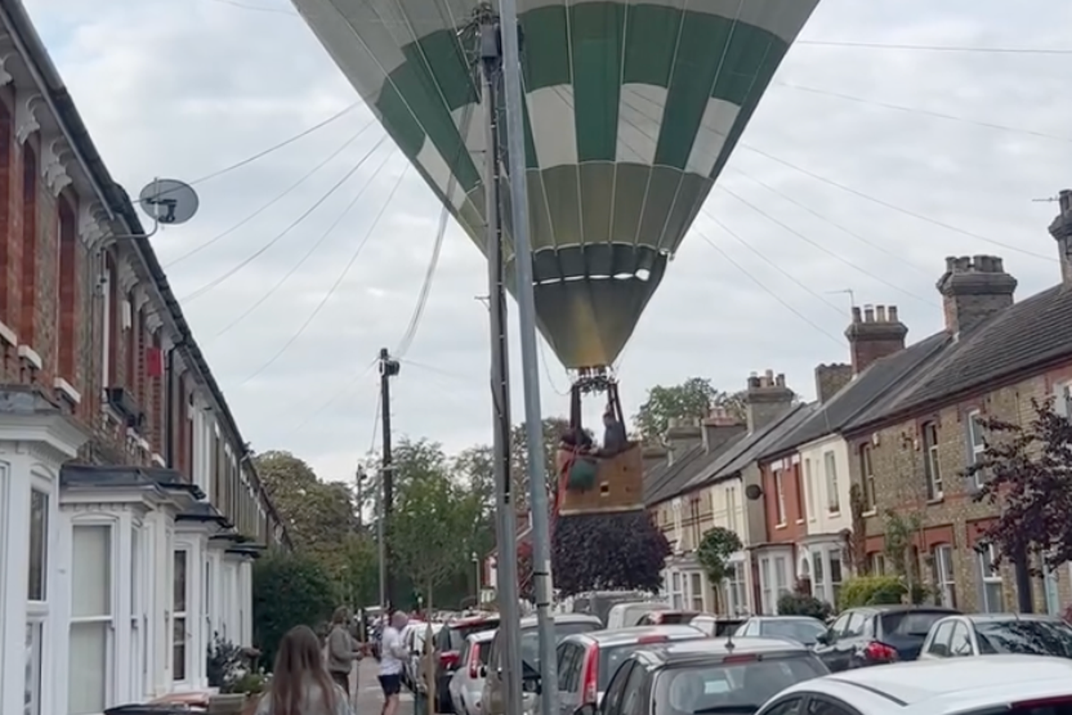 Moment hot air balloon lands on street in front of stunned residents