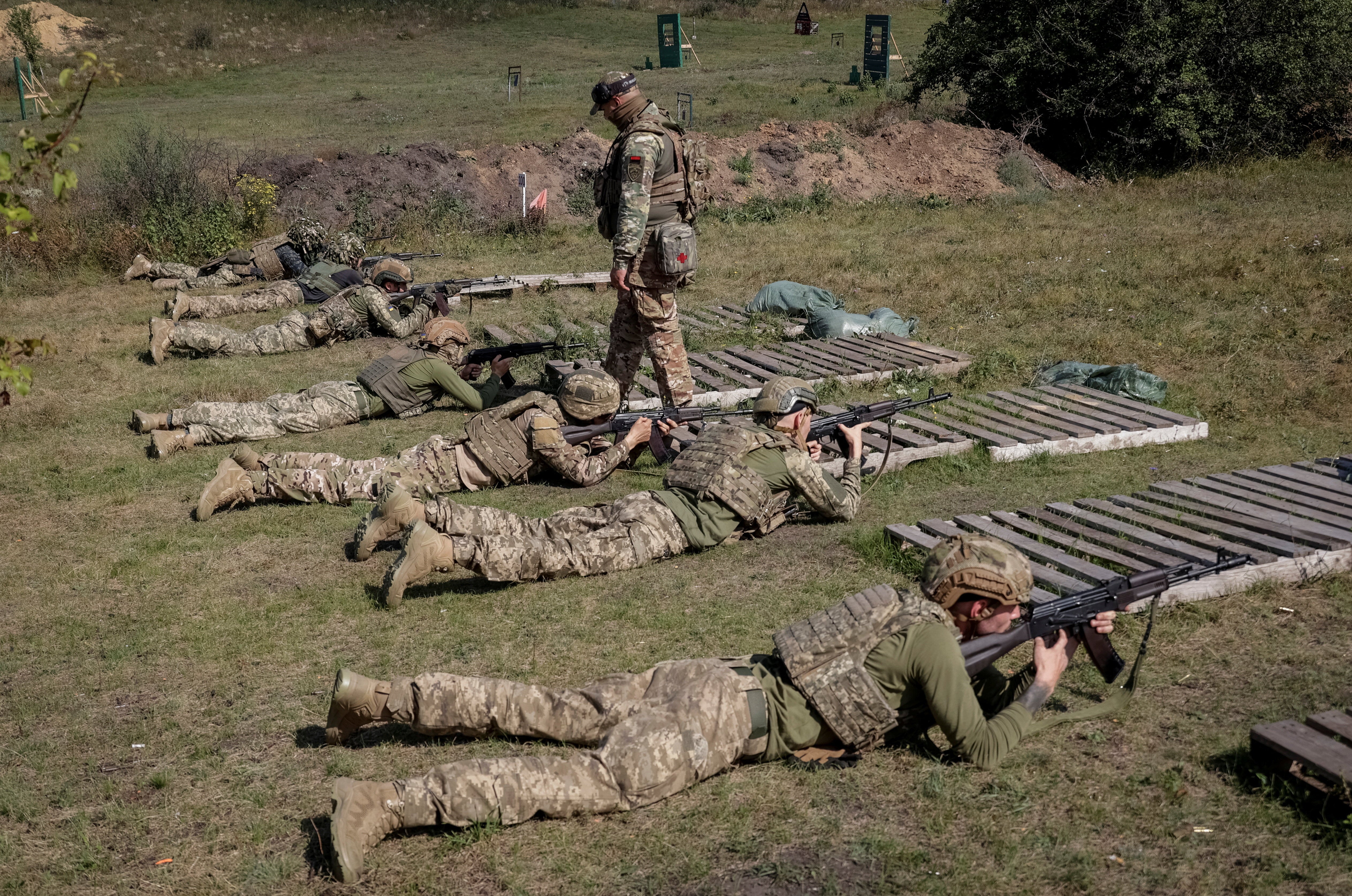 Ukrainian servicemen attend a training as recruits in Kharkiv region