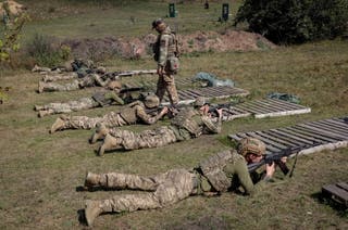 Ukrainian servicemen attend a training as recruits in Kharkiv region