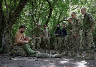 Ukrainian servicemen attend a training as recruits in Kharkiv region