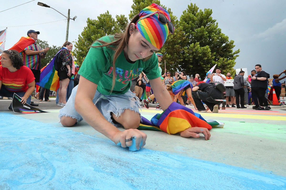 Advocates use chalk to color in rainbow crosswalk near Pulse nightclub that was removed on Trump’s order