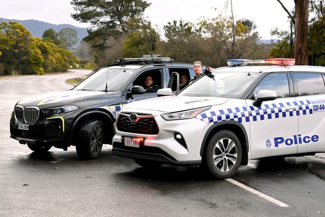 <p>Police man a road block to a property as the search intensifies for a fugitive linked to the murder of two police officers in Porepunkah on 27 August 2025</p>