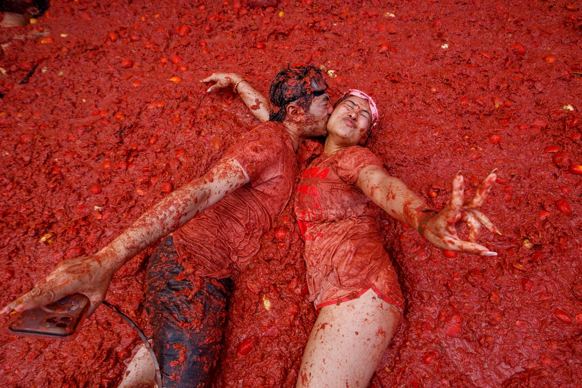 Photos show revelers taking part in Tomatina, the tomato-throwing festival in Spain
