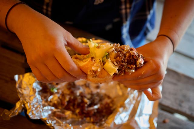 <p>A person holds a sandwich at the Stejk Street Food food place in Kiruna, Sweden, Sunday, Aug. 17, 2025. (AP Photo/Malin Haarala)</p>