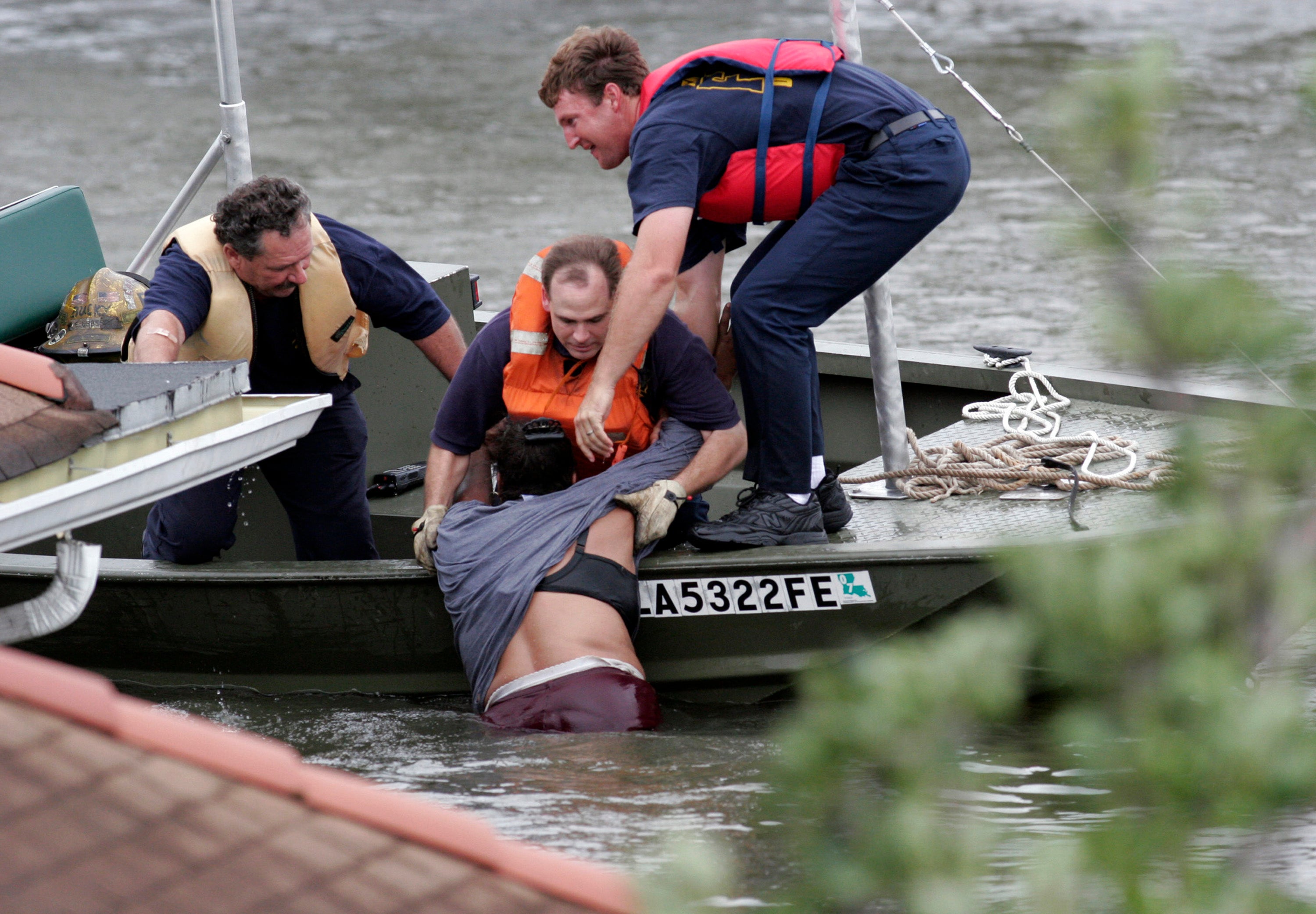 Rescue workers pull a woman from the rising flood waters from Hurricane Katrina in New Orleans, Louisiana. Now, 20 years since the monster storm, experts say the federal government would be ill-equipped to handle such a storm