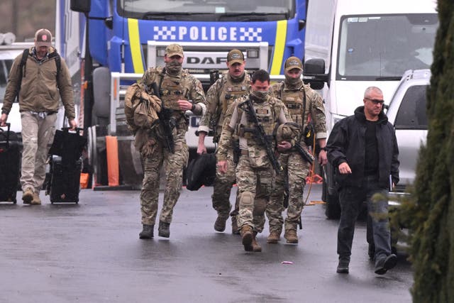 <p>Heavily armed police gather at a police staging point during the search for a fugitive linked to the murder of two police officers, in Porepunkah on 28 August 2025. - Police searched the Australian bush for a heavily armed 56-year-old gunman still on the run a day after allegedly killing two officers and wounding a third</p>