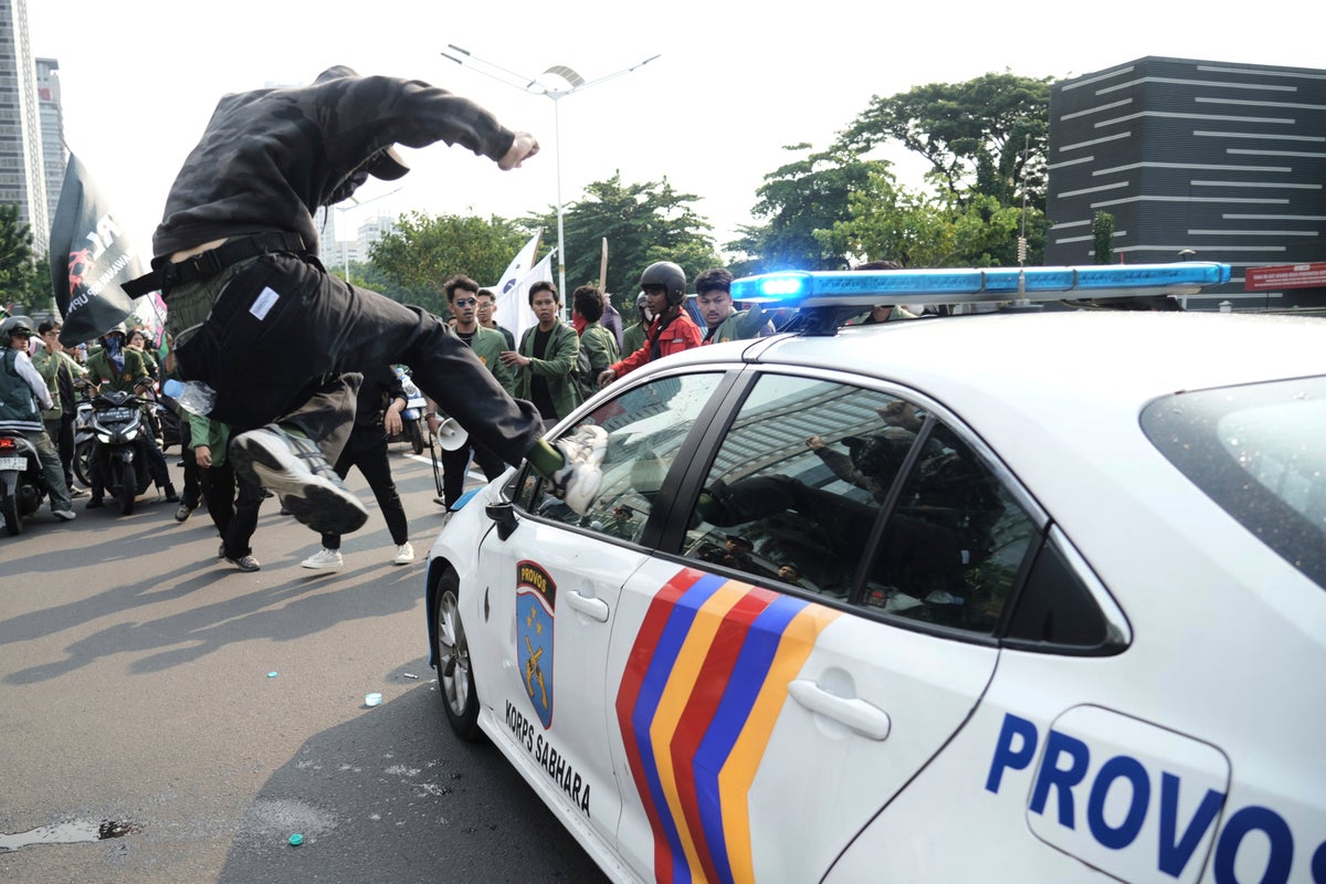 Photos of violent clashes between riot police and protesters in Indonesia