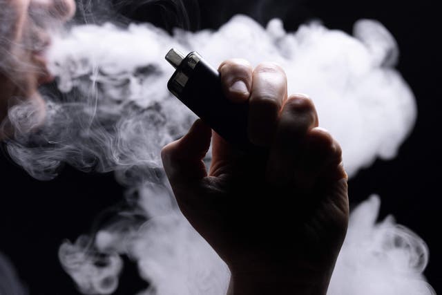 <p>This photograph taken on 30 May 2023 show an individual vaping an electronic cigarette</p>