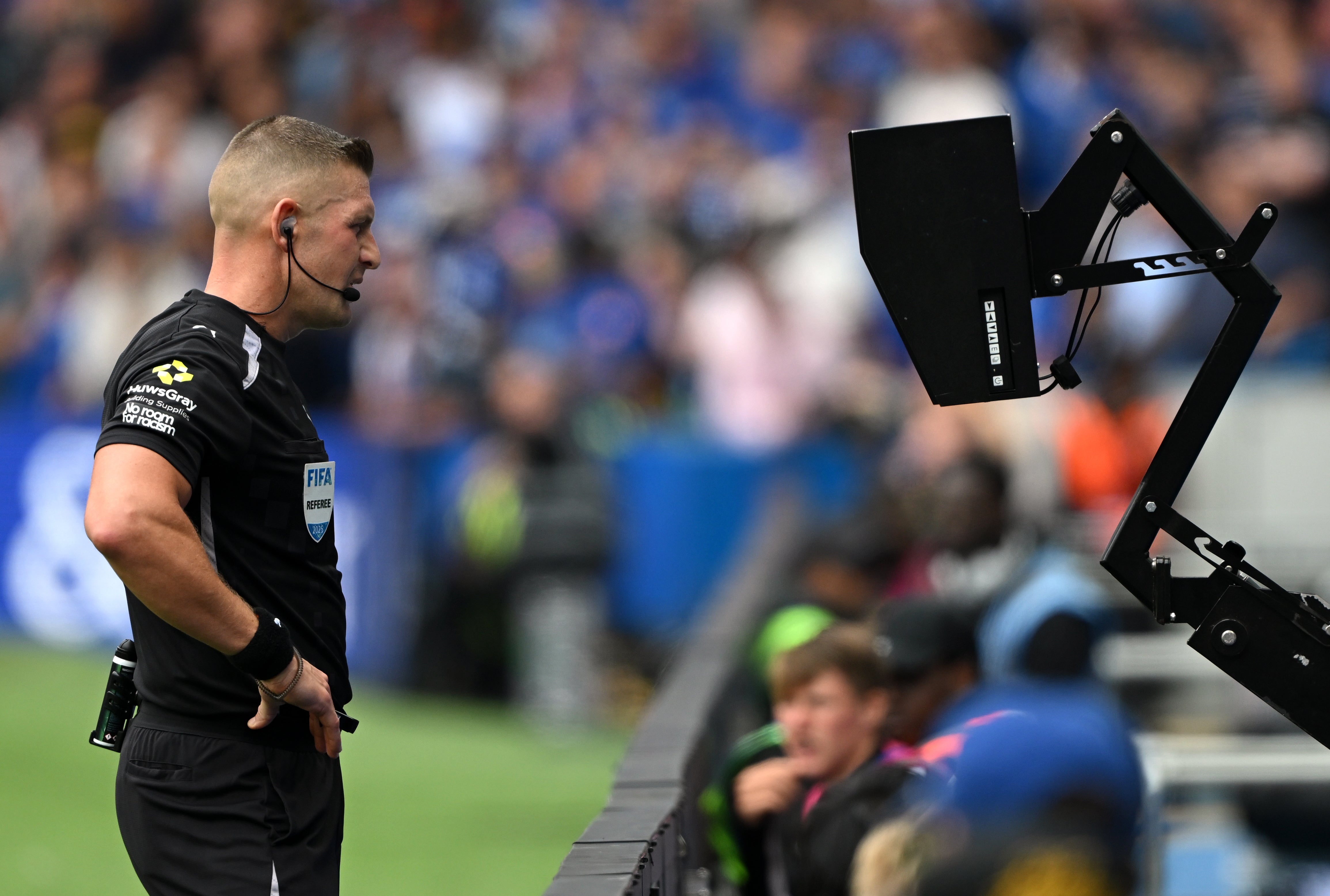 Referee Robert Jones checks the VAR screen