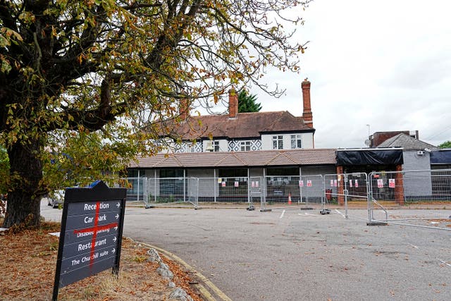<p>A sign painted with a red cross is seen on Saturday afternoon outside the Bell Hotel in Epping on August 30, 2025</p>
