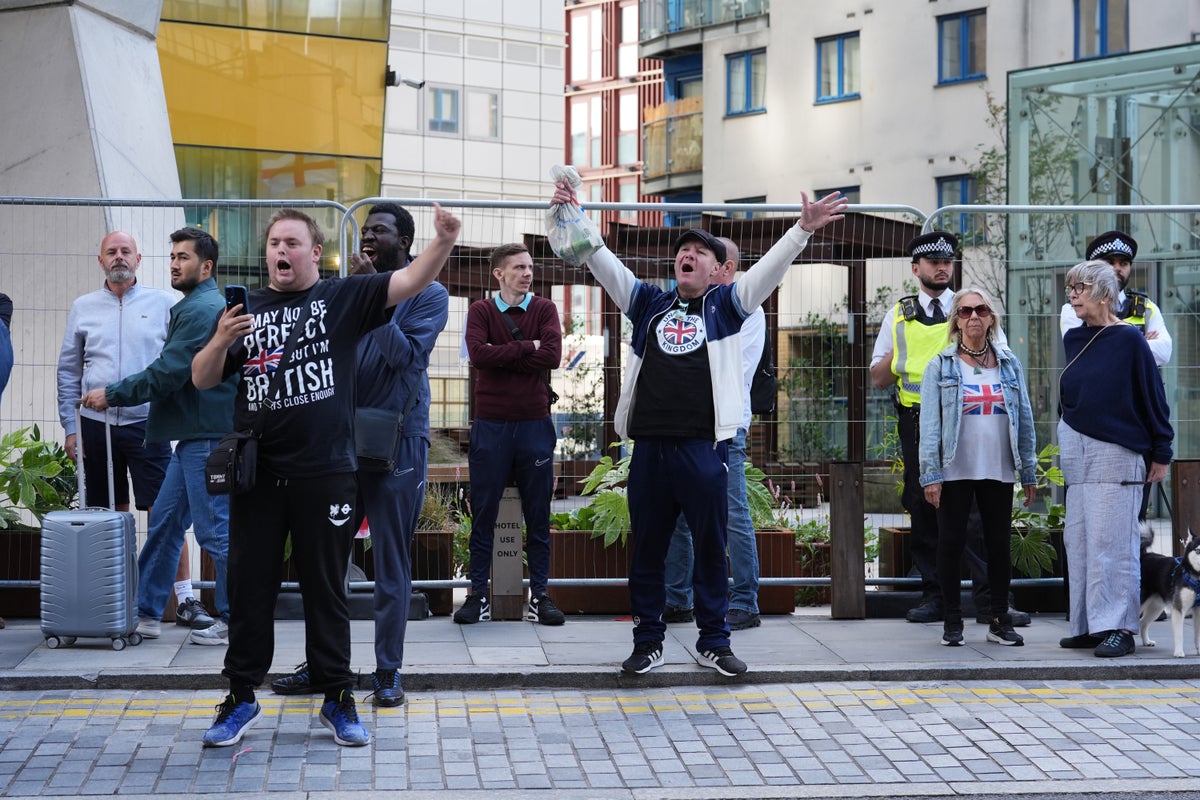 Police officer punched as masked anti-asylum protesters march through Canary Wharf shopping centre