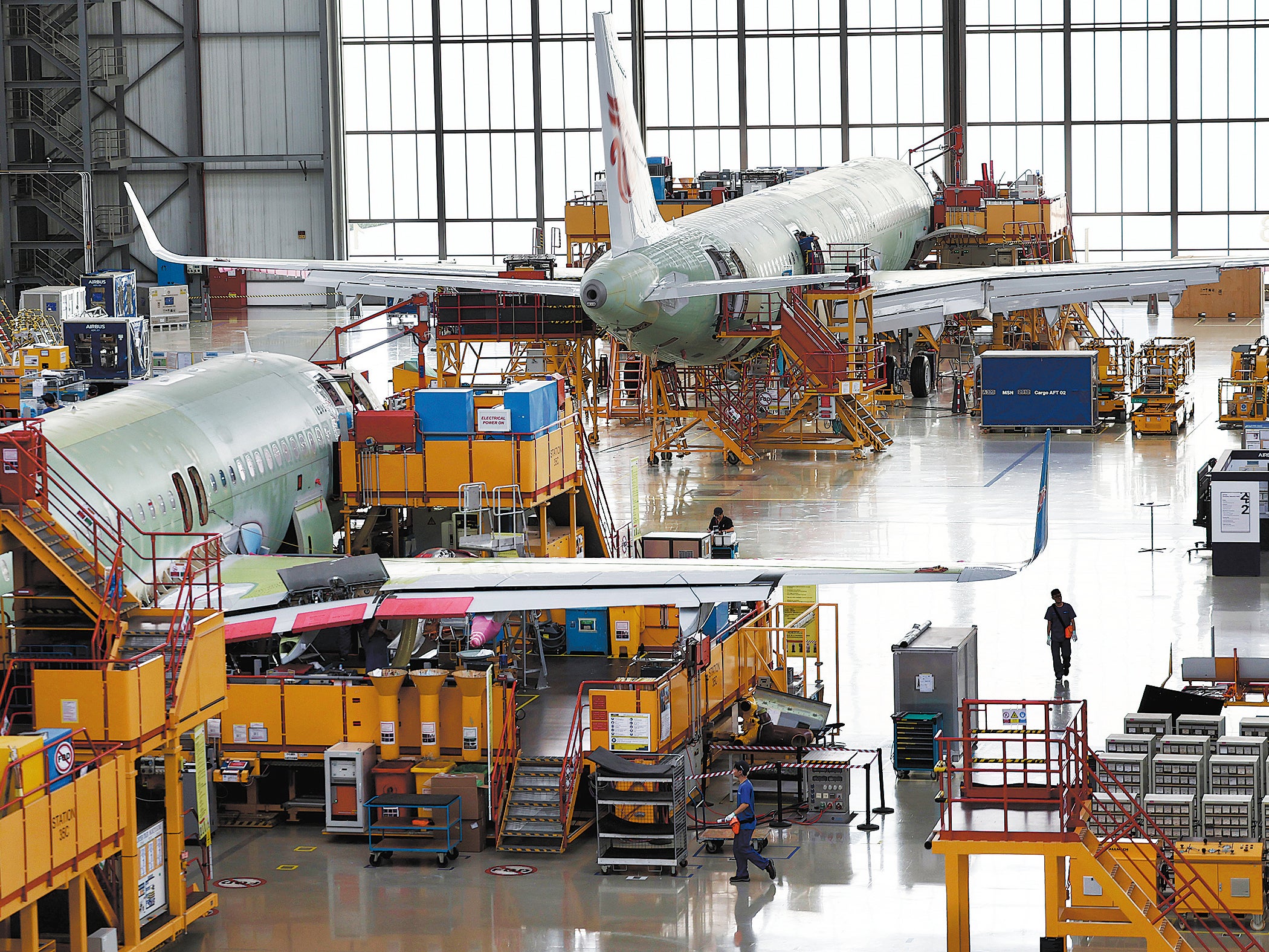 Employees assemble aircraft on the first final assembly line for the Airbus A320 series in Tianjin on 1 August