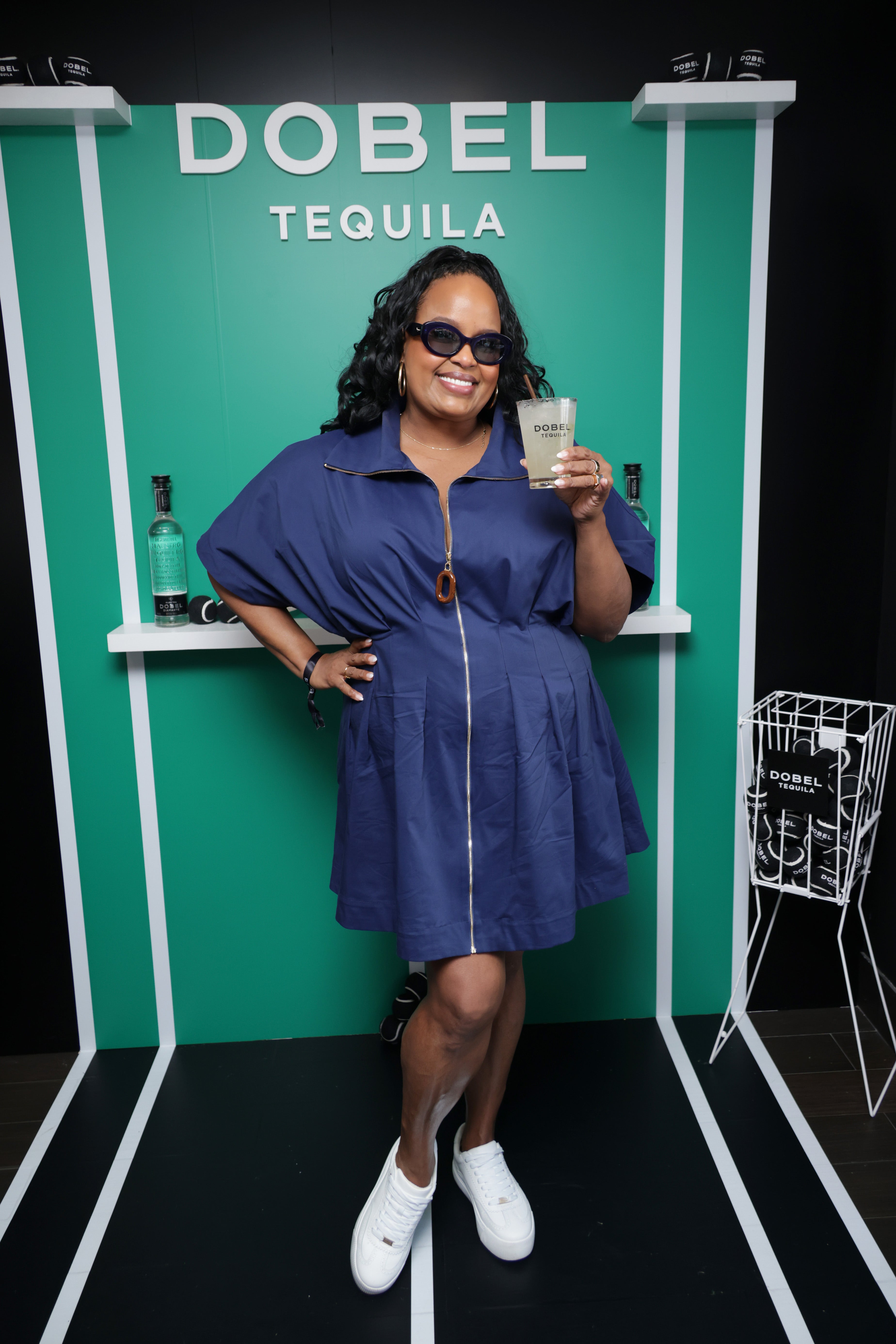 'The White Lotus' star Natasha Rothwell donned a navy zip-up dress and completed the look with crisp white sneakers for a polished yet sporty look on August 31