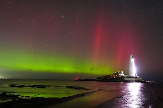 The Northern Lights seen at St Mary’s lighthouse in Whitley Bay (Owen Humphreys/PA)