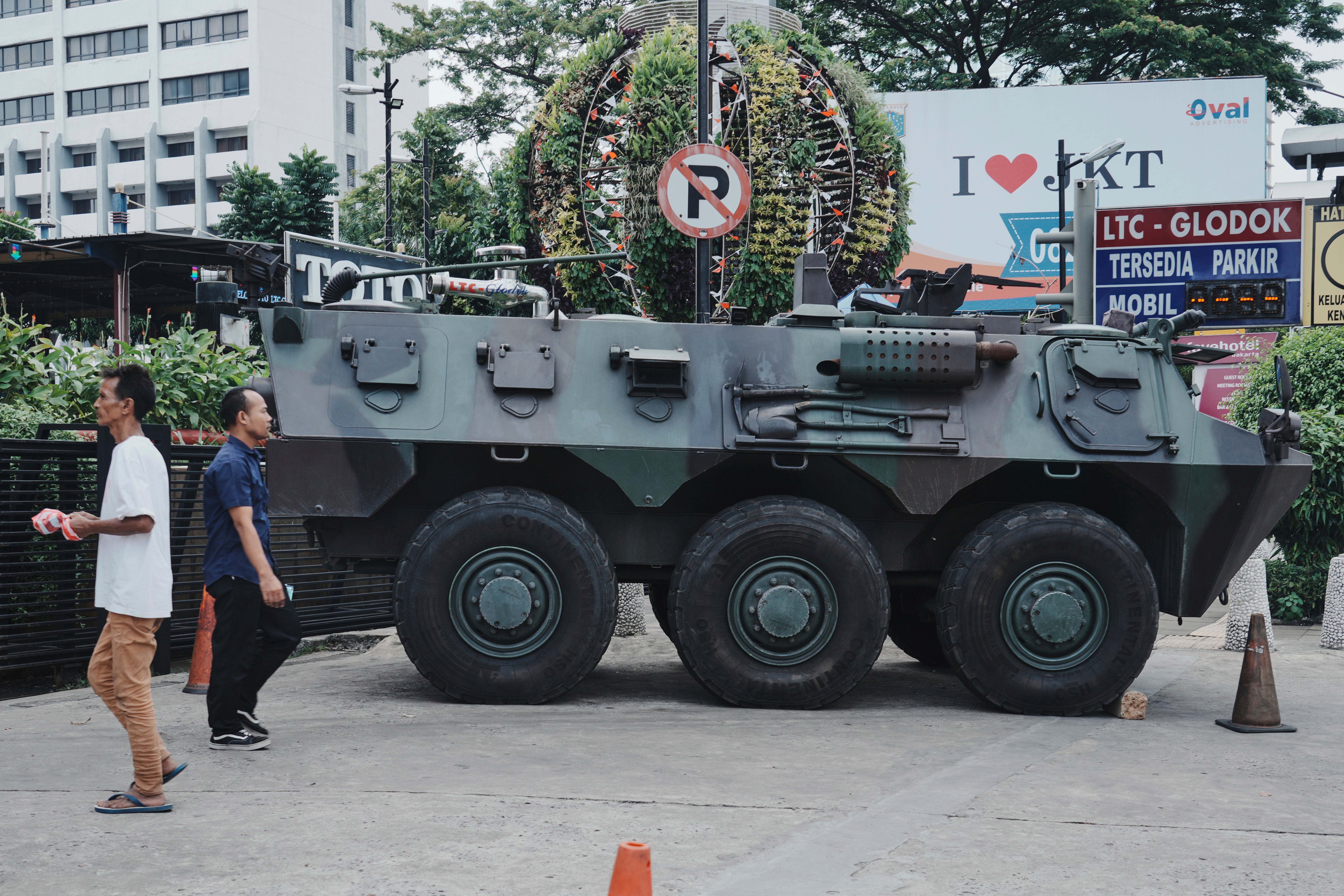 <p>People walk past an army armoured vehicle parked outside a shopping centre following days of violent protests against lawmakers' perks and privileges, in Jakarta, Indonesia, Monday, 1 September 2025</p>
