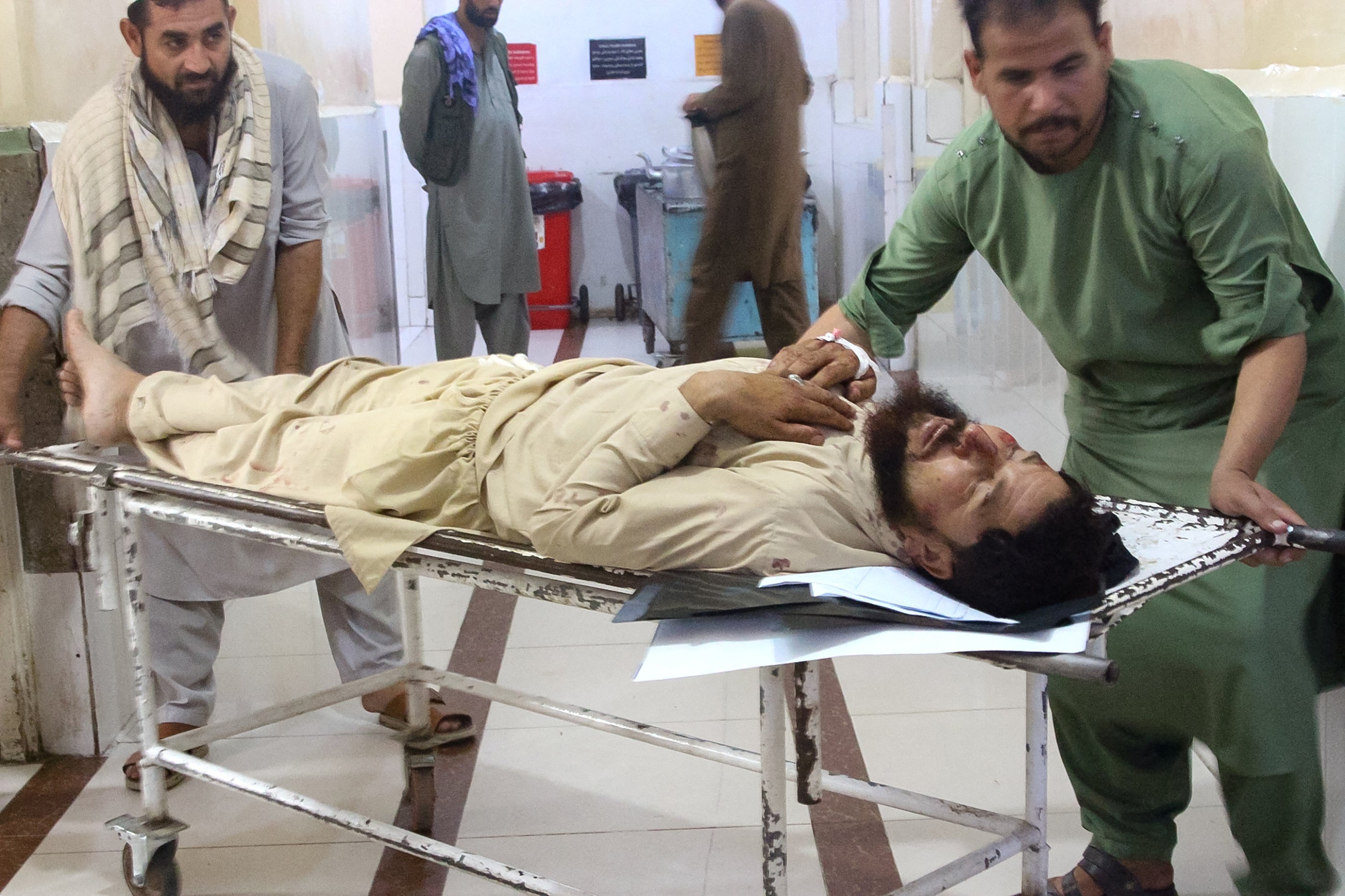Volunteers carry an injured man to a hospital after an earthquake in Afghanistan's Jalalabad on September 1, 2025. Nine people died when a 6.0-magnitude earthquake and powerful aftershock rattled eastern Afghanistan