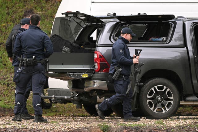 <p>Heavily armed police gather at a staging point during a search for a fugitive linked to the murder of two police officers, in Porepunkah on 29 August 2025</p>