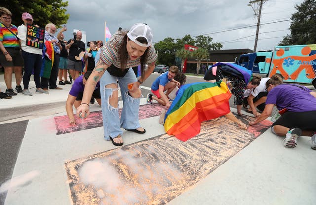 <p>Demonstrators use chalk to color the street during a protest at the Pulse memorial crosswalk in Orlando, Florida, on August 21</p>