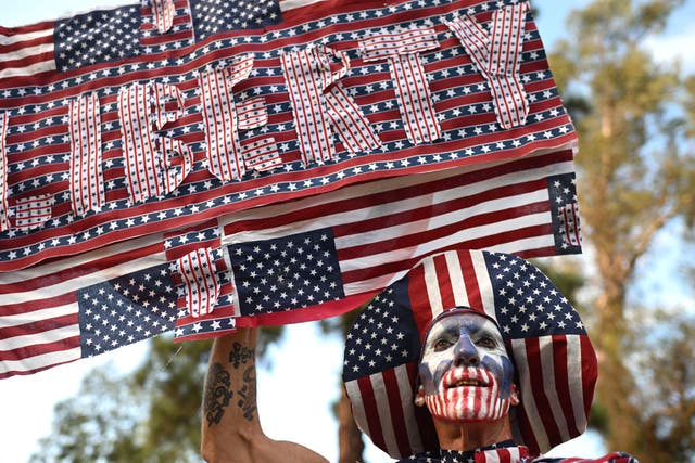 <p>A protester holds a "Liberty" sign at a "People's Block Party" gathering organized as part of a national day of action on Labor Day to protest the "billionaire takeover" of the U.S. in Elysian Park in Los Angeles, California</p>