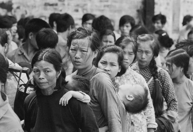 <p>People waiting in line at the Government Dockyard in Hong Kong after leaving Vietnam</p>