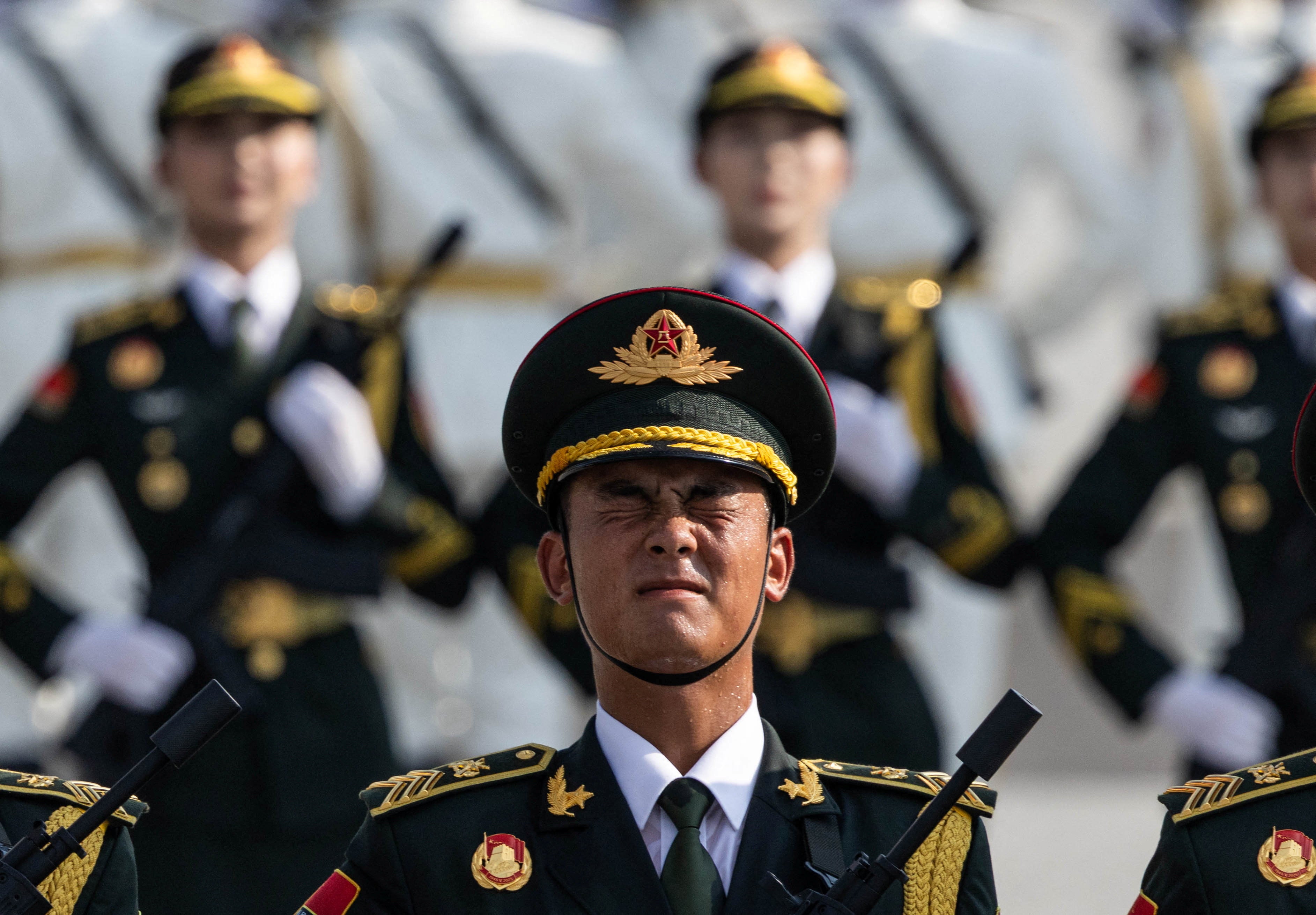 A soldier of the People's Liberation Army (PLA) of China reacts during training