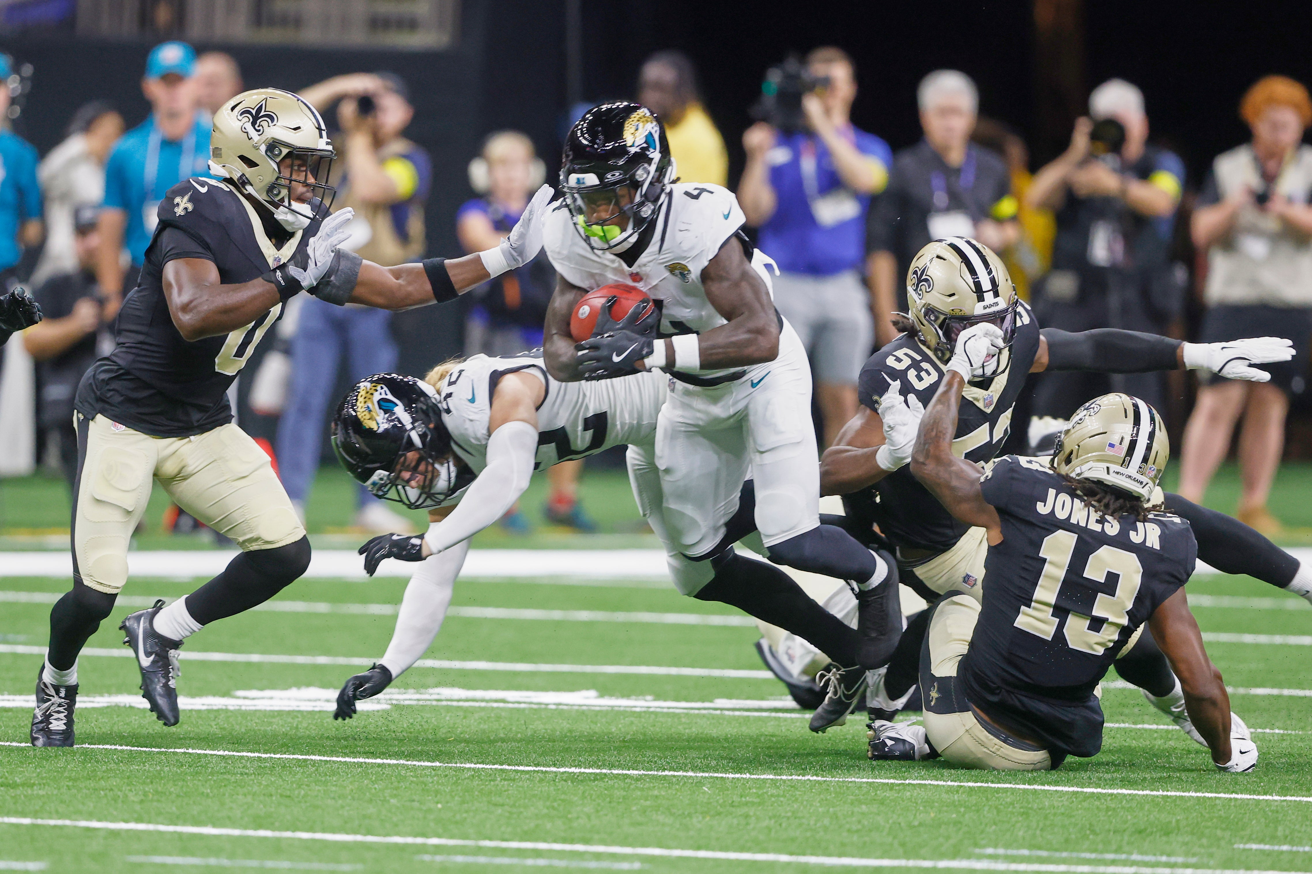 <p>Jacksonville Jaguars running back Tank Bigsby (4) returns a kickoff as he tries to get past New Orleans Saints safety Ugo Amadi (0) </p>