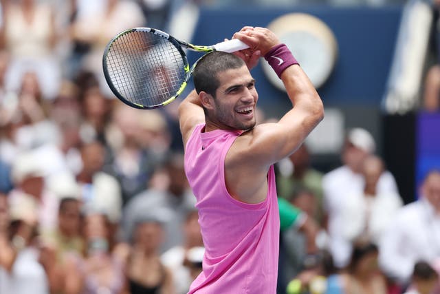 <p>Alcaraz celebrating on court with a golf swing-inspired move</p>
