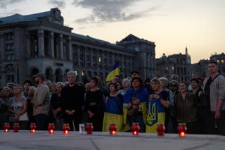 People hold flags during a memorial service for former Ukrainian parliamentary speaker Andriy Parubiy
