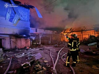 Firefighters work at the site of car garages hit by a Russian drone strike, amid Russia's attack on Ukraine, in the city of Bila Tserkva, Kyiv region